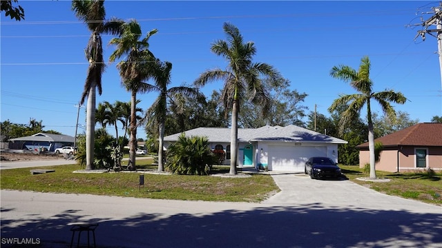 view of front of home featuring a garage and a front lawn