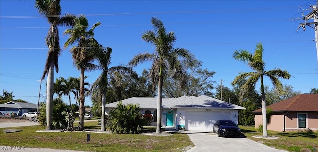 view of front of property with a garage and a front yard