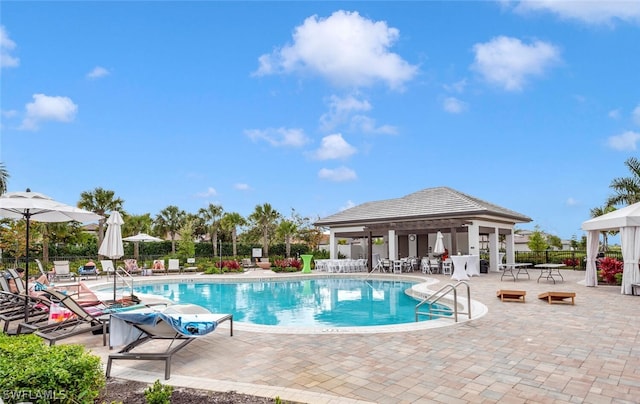 view of swimming pool with a patio and a gazebo