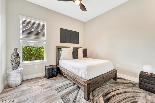 bedroom with ceiling fan and light wood-type flooring