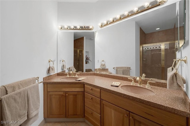 bathroom with tile patterned floors, a shower with shower door, and vanity