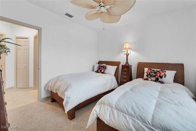 tiled bedroom with ceiling fan