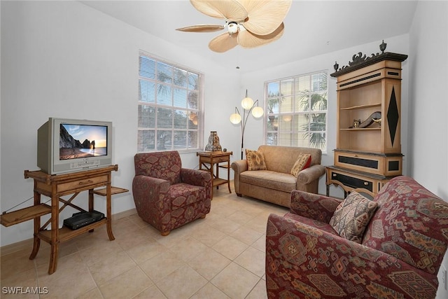 sitting room with a healthy amount of sunlight, light tile patterned floors, and ceiling fan