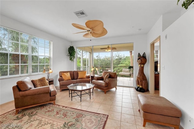 tiled living room featuring plenty of natural light and ceiling fan