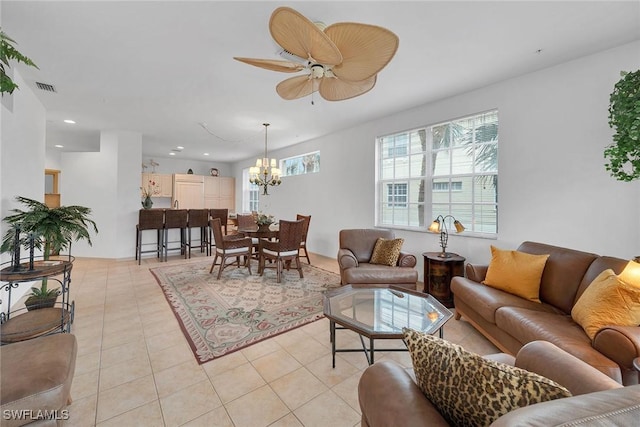 living room featuring light tile patterned floors and ceiling fan with notable chandelier