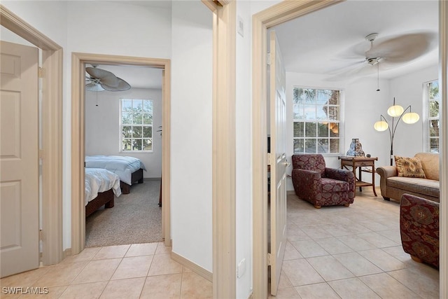 hall with light tile patterned floors