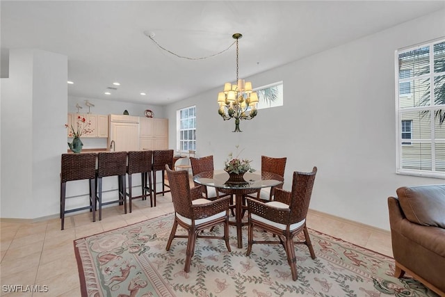 tiled dining area featuring a chandelier