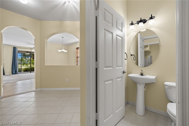 bathroom with tile flooring and toilet