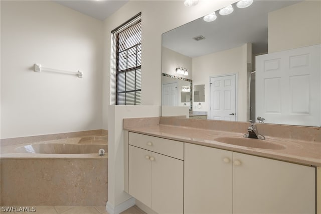 bathroom featuring a bathtub, tile flooring, and vanity