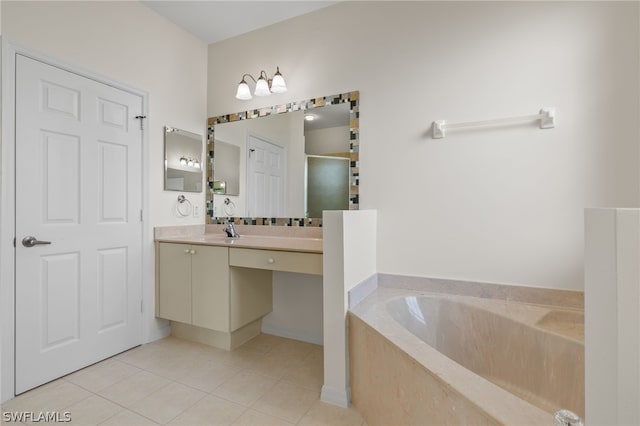 bathroom with tile flooring, vanity with extensive cabinet space, and a bathing tub