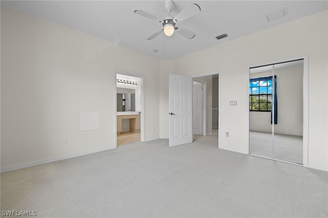 unfurnished room featuring light colored carpet and ceiling fan