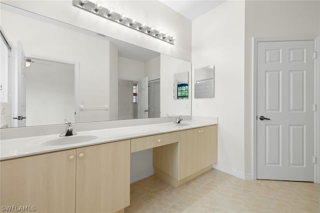 bathroom with tile flooring and double vanity