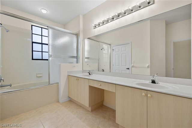 bathroom with shower / bath combination with glass door, oversized vanity, double sink, and tile floors