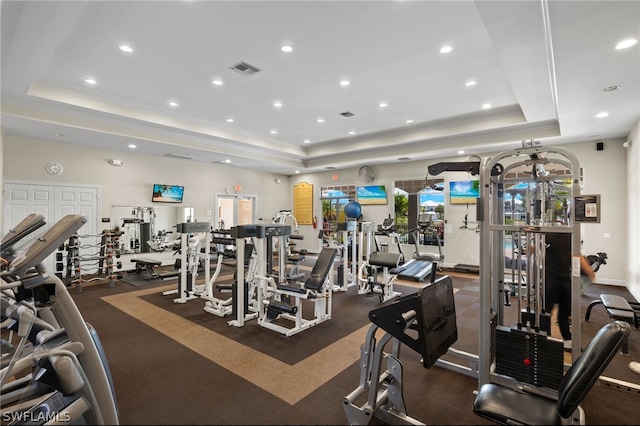 exercise room featuring a raised ceiling