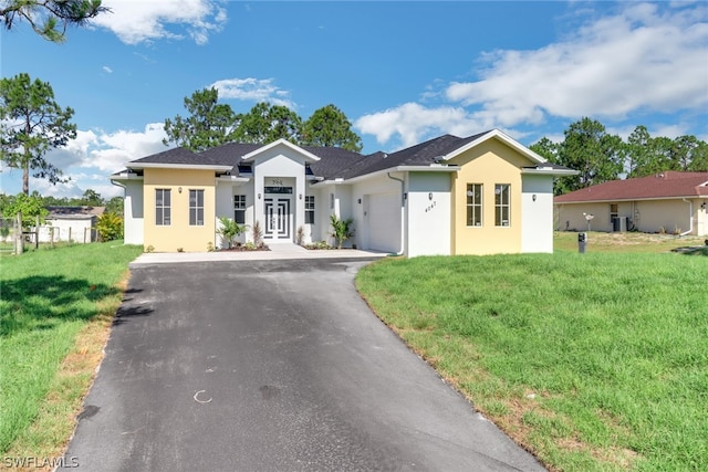 single story home featuring a front lawn