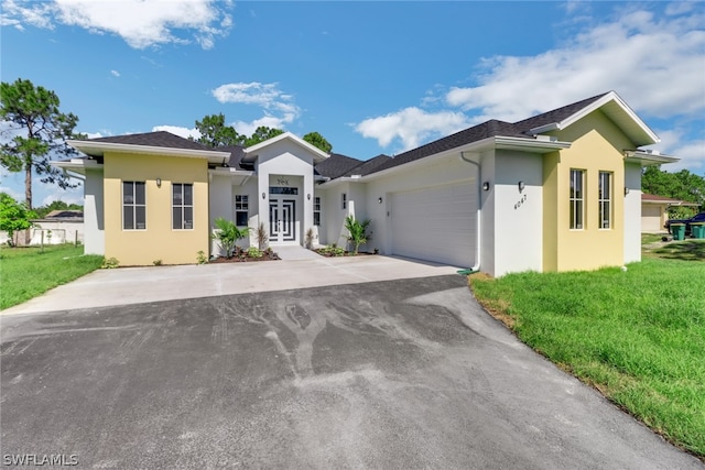 view of front of house with a garage and a front yard