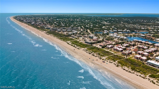 birds eye view of property featuring a beach view and a water view