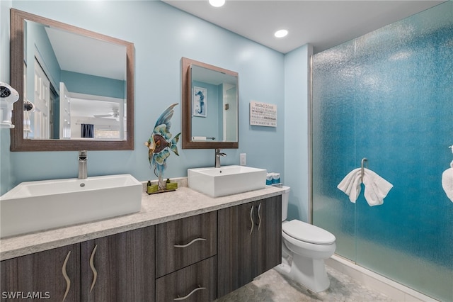 bathroom with dual vanity, walk in shower, tile flooring, and toilet