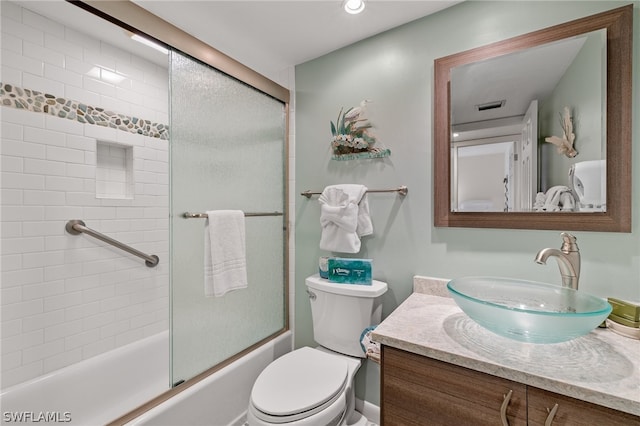 full bathroom with shower / bath combination with glass door, vanity, and toilet