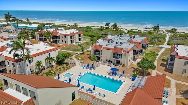 exterior space with a patio area, a view of the beach, and a water view