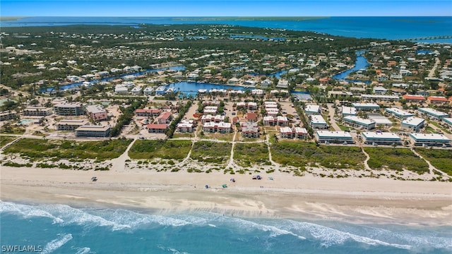 birds eye view of property with a view of the beach and a water view