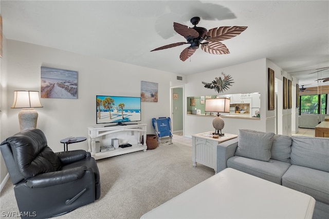 carpeted living room with ceiling fan