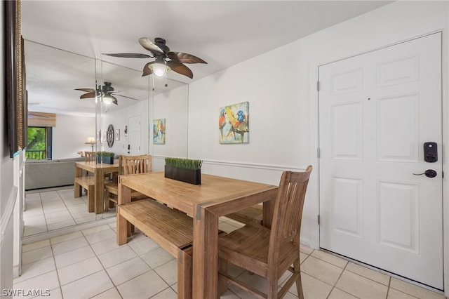 dining room with ceiling fan and light tile flooring