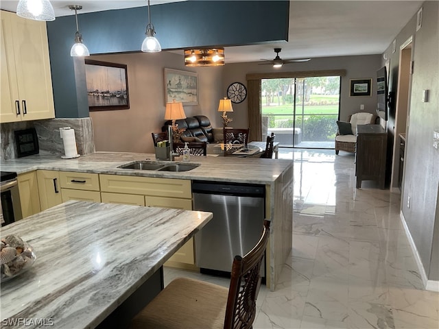 kitchen with backsplash, ceiling fan, sink, cream cabinetry, and dishwasher