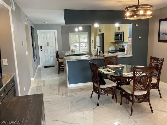 dining room with sink and a notable chandelier