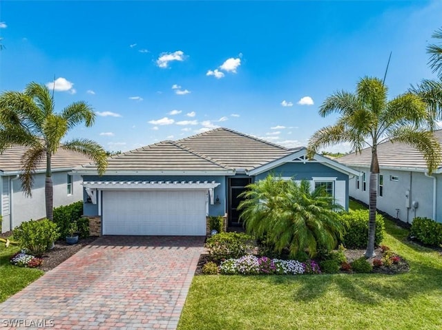 ranch-style house with a front lawn, decorative driveway, a garage, and stucco siding