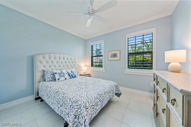 tiled bedroom with ornamental molding and ceiling fan