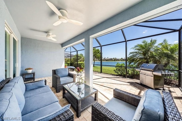 sunroom with a water view and ceiling fan