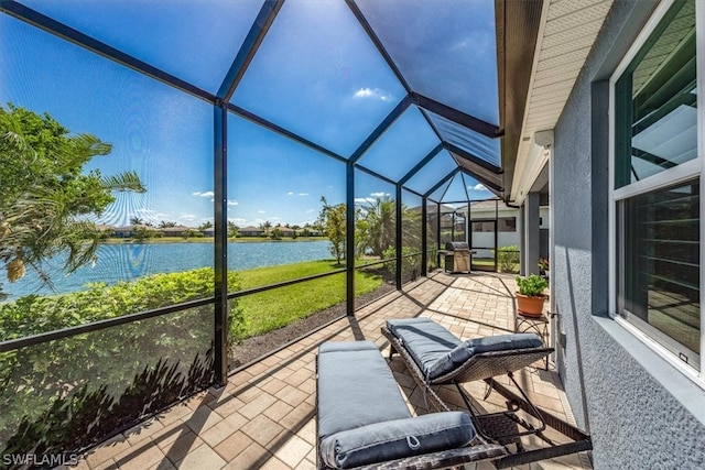 sunroom / solarium with a water view and vaulted ceiling