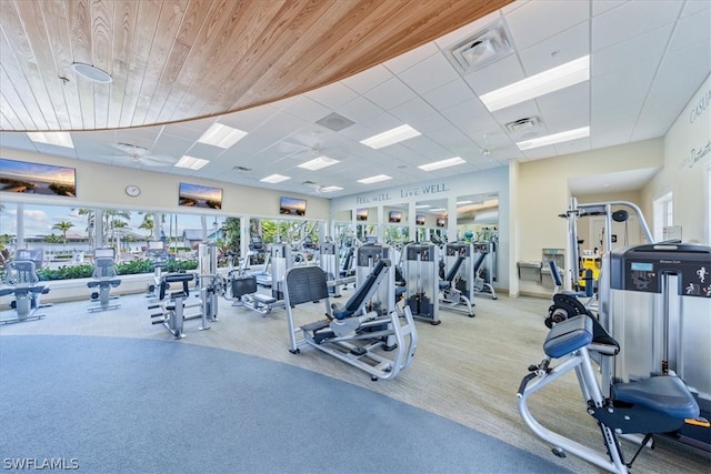 workout area featuring wooden ceiling, carpet, visible vents, and a paneled ceiling