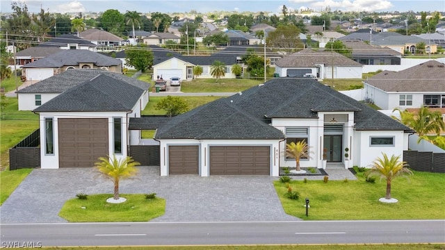 view of front of property with a garage and a front yard