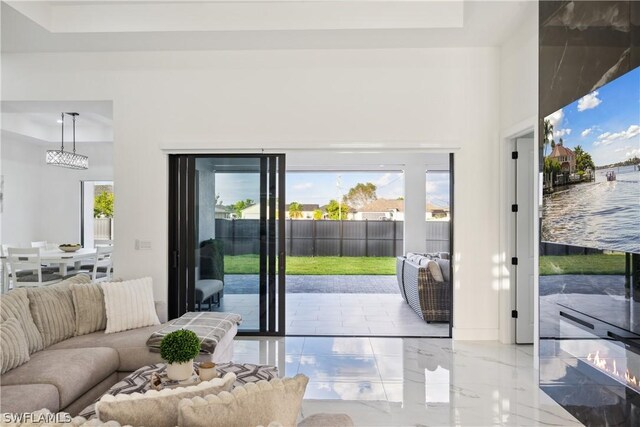 doorway to outside with a tray ceiling