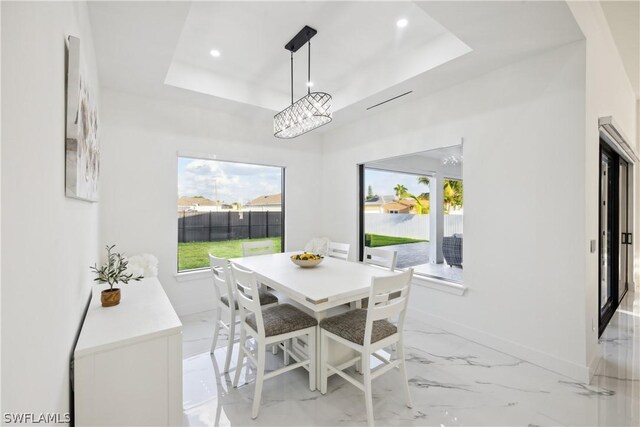 dining area featuring a tray ceiling