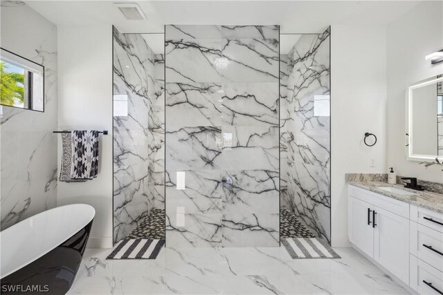 bathroom featuring vanity and separate shower and tub