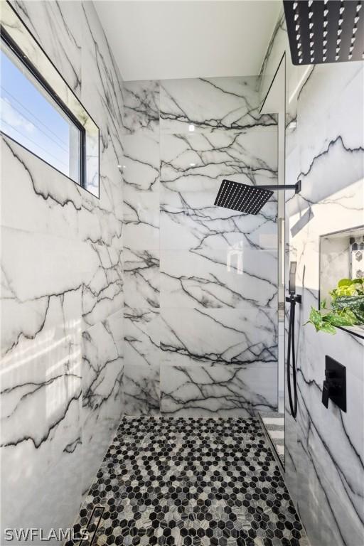 bathroom with a tile shower