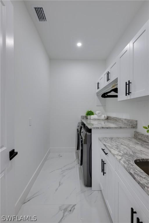 laundry area featuring cabinets and separate washer and dryer