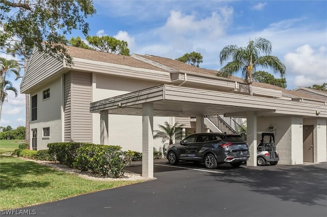 view of parking / parking lot featuring a carport