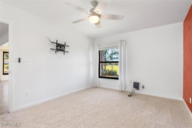 spare room with carpet flooring and ceiling fan