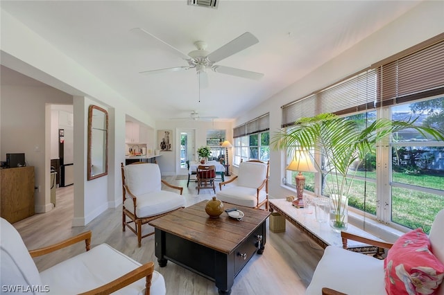 living room with wood-type flooring, french doors, and ceiling fan