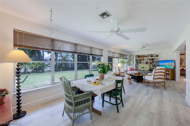 dining area with light hardwood / wood-style floors and ceiling fan