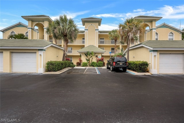 view of front of house featuring a balcony and a garage