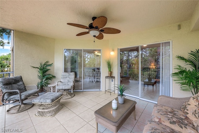 tiled living room featuring plenty of natural light, ceiling fan, and a textured ceiling