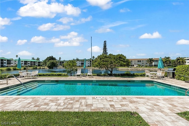 view of swimming pool featuring a patio area and a grill