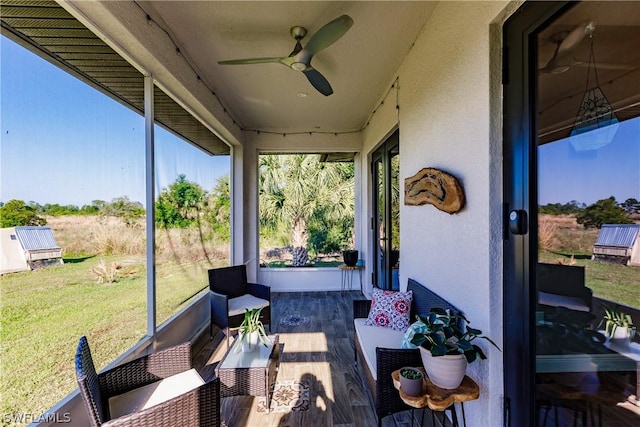 sunroom featuring ceiling fan