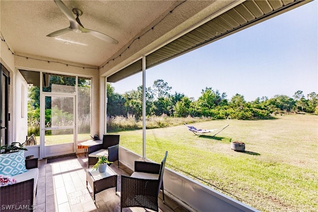 sunroom featuring ceiling fan