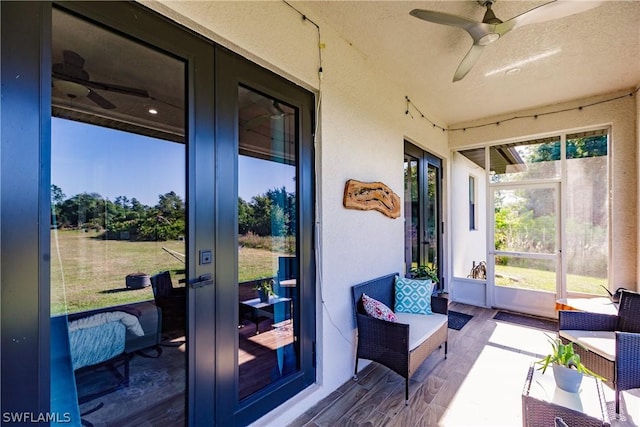 sunroom / solarium with ceiling fan